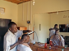 Uganda: Barber shop using solar electricity in Uganda. The owner purchased the system from a solar company supported by GIZ. <br />
© GIZ / Monika Rammelt